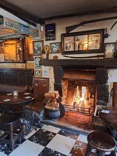 an old fashioned restaurant with a fireplace and checkered flooring in front of it