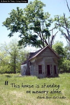 an old run down house sitting in the middle of a field with a quote written on it