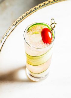 a drink with a cherry on the rim and garnished in sugar, sits on a tray