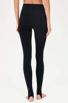 Our famous, form fitting high waist legging redesigned as a stirrup tight. Our ultra luxe Airweight fabric has a supremely soft hand and second skin comfort. BEST FOR: hot yoga, barre, Pilates. Model is 5'10" and wears a size small. Sleek Compressive Leggings For Pilates, Sleek Fitted Leggings For Pilates, Sleek Compressive Full Length Leggings, Sleek Tight Bottoms For Pilates, Sleek Fitted Tights For Yoga, Minimal Stretch Yoga Pants For Pilates, Sleek Yoga Tights, Sporty Black Footless Tights, Black Athleisure Smoothing Bottoms