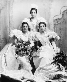 an old photo of three women in dresses