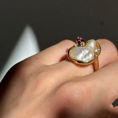 Estate/ vintage 14KT yellow gold genuine, blister pearl, emerald-cut pink tourmaline, and round diamond ring. A designer and absolutely unique piece! Size 6 Sizable by us for a fee, or your local jeweler Weight: 6 grams Front Measures: 20mm x 18mm Tourmaline measures approx.: 6mm x 4mm (2) natural diamonds Stamped 14k and MMT hallmark Heirloom Multi-stone Pearl Ring As Gift, Heirloom Multi-stone Pearl Ring Gift, Fine Jewelry Pearl Ring With High Luster For Gift, Diamond Pearl Ring With High Luster For Gift, Gift Pearl Ring With High Luster And Diamond, Round Diamond Ring, Pink Tourmaline, Emerald Cut, Round Diamond