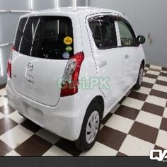 a small white car parked in a garage