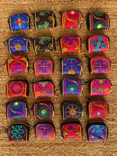 many colorful bags are lined up together on the floor and ready to be used as purses