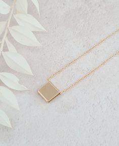 The square pendant necklace is stylish and a versatile piece of jewellery that adds a touch of modern sophistication to any outfit.  The pendant is shiny and polished measuring 10mm x 10mm.  The necklace is gold plated. Minimalist Jewelry With Delicate Chain And Square Pendant, Square Minimalist Jewelry For Everyday, Minimalist Everyday Jewelry With Square Pendant, Modern Square Pendant Necklace For Everyday, Minimalist Jewelry With Delicate Rectangular Chain, Minimalist Rectangular Jewelry With Delicate Chain, Modern Everyday Necklace With Square Pendant, Simple Rectangular Necklace For Gift, Modern Everyday Necklace