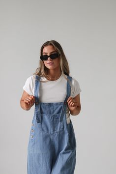 Frankie Denim Overalls are crafted from washed denim for a stylish, weathered look. Featuring an oversized and loose fit with adjustable straps and distressed details, these overalls are designed to provide a comfortable, personalized fit. Model Measurements: Hips 34” Waist 25” Bust 32” Height 5’6.5, wearing a size small Material: 100 Cotton Measurements XS: Hips: 42"| Length: 44" (taken from top of front of overalls to ankle cuff) S: Hips: 42"| Length: 44.5" (taken from top of front of overalls Bridesmaid Tops, Washed Denim, Denim Overalls, Man Swimming, Romper Pants, New Arrival Dress, Trending Dresses, Summer 2024, To Miss