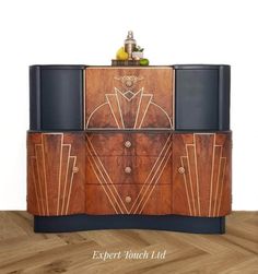 an art deco sideboard with two drawers and three doors on the front, one door open