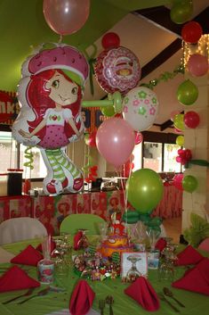 the table is set up with balloons and other decorations for a birthday party or baby shower