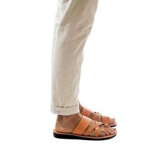 Model wearing The Good Shepherd tan, handmade leather slide sandals with toe loop Mens Slide Sandals, Ankle Strap Sandals Flat, Toe Ring Sandals, Toe Loop Sandals, Good Shepherd, Leather Gladiator Sandals, Closed Toe Sandals, Ankle Strap Flats, The Good Shepherd