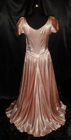 "This truly elegant gown is in Great to Excellent condition. It has a beautiful heavily ruched bodice with a basque waist. It has a side hidden metal zipper and on the back of the zipper are patent numbers that date 1929, so this could possibly be a late 20's dress/gown. It is much more gorgeous than the picture can show, a phenomenal find, I may not come across another one like this for a long time, you had best buy it right away! Bust/Chest - 36\", Waist - 28\", Hips - 38\", Length - 55\", Swe Full Length Ruched Evening Dress, Vintage Victorian Satin Ball Gown, Vintage Satin Victorian Ball Gown, Vintage Satin Victorian Ball Gown Dress, Victorian Fitted Dress For Debutante Ball, Fitted Full-length Evening Dress With Pleated Bodice, Fitted Full Length Evening Dress With Pleated Bodice, Full Length Evening Dress With Fitted Bodice, Empire Waist Dresses With Fitted Bodice For Vintage Events