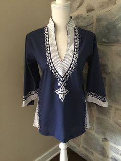 This embroidered tunic shirt is a great, fun shirt with bell, 3/4 length sleeves. The embroidery is amazing and it is in great condition! Size - Small Shoulder to Bottom - 26" Shoulder to Shoulder - 15.5" Summer Cotton Kurta With Embroidered Sleeves, Spring Embroidered Kurta With 3/4 Sleeves, Spring Kurta With Floral Embroidery And 3/4 Sleeves, Bohemian Long Sleeve Tops With Machine Embroidery, Long Sleeve Tunic With Embroidered Hem, Long Sleeve Kurta With Geometric Embroidery, Casual Long Sleeve Embroidered Kurta, Long Sleeve Cotton Kurta With Geometric Embroidery, Traditional Long Sleeve Tops For Beach