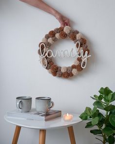 a wreath with the word mommy written on it and two coffee mugs next to it