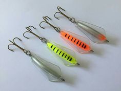 five different types of fishing lures on a white surface