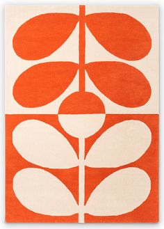 an orange and white rug with flowers on it