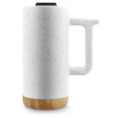 a white ceramic coffee mug with wooden handle