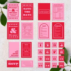 red and pink wedding stationery with green leaves