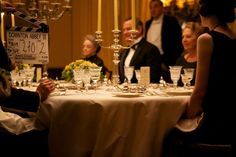 a group of people sitting around a dinner table