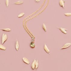 "\"A beautiful gold pendant necklace with a unique design. August's birthstone, the peridot, is combined with two tiny white diamonds. A special gift for you or someone you love!\" ♥♥ GEMSTONES ● PERIDOT: The peridot is 5mm x 3mm (approx. 0.19in x 0.11in). It weighs 0.21ct. ● DIAMONDS: The round diamonds are 0.9mm (approx. 0.035in). Their total weight is 0.01ct. A certificate will be provided. Please keep in mind that the dimensions and the weight may slightly vary. ♥♥ DETAILS The pendant is 9.5 Fine Jewelry Peridot Necklace For May Birthstone, Diamond Birthstone Pendant Charm Necklace, Yellow Gold Birthstone Necklace With Diamond Accents As Gift, Yellow Gold Birthstone Pendant Necklace As Gift For Her, Yellow Gold Peridot Necklace Gift, Peridot Necklace With Round Pendant For Gift, Diamond Birthstone Pendant Necklace, Birthstone Pendant Diamond Necklace As Gift, May Birthstone Yellow Gold Necklace For Her