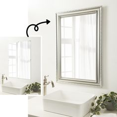 a bathroom sink sitting under a mirror next to a plant in a vase on the counter