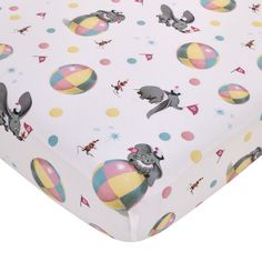 a white sheet with elephants on it and colorful balls around the edges, all printed in different colors