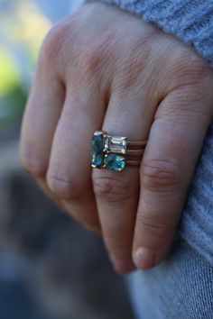 This waterfall of color is simple, classic and bold. You will be intrigued by all that it can do. Stack it with other colorful rings or wear it alone. Deco in feel, but super modern in taste. This 14k recycled gold stacking stone ring features a baguette cut blue tourmaline set in two-sided bezel. Pictured in:14k yellow gold1.26ct blue green tourmaline2mm wide Jennifer Dawes Design works with responsible diamantaires. Due to fluctuations in the diamond market, pricing varies on diamonds based on Modern Multi-stone Emerald Cut Jewelry, Emerald Cut Gemstone Rings For Everyday, 14k White Gold Stackable Emerald Cut Rings, Modern 14k Gold Stackable Sapphire Ring, Emerald Cut Gemstone Stackable Rings In 14k Gold, Modern Stackable Emerald Cut Gemstone Rings, Modern 14k Gold Emerald Cut Birthstone Ring, Modern 14k Gold Three Stone Jewelry, Modern Three Stone 14k Gold Jewelry