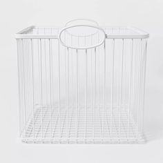 a white wire basket with a handle on the top and bottom, in front of a white background