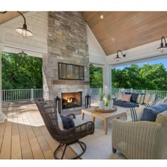 a covered porch with furniture and a fire place