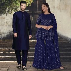 Menswear:- Art Silk Kurta in Navy Blue. This Readymade attire is Enhanced with Buttons. Crafted in Chinese Collar Neck and Full Sleeve. Available with an Art Silk Pant in Navy Blue Do note: Footwear shown in the image is for presentation purposes only. Half to one inch may vary in measurement. (Slight variation in actual color vs. image is possible) Salwar Kameez:-Readymade Faux Georgette Pakistani Suit in Navy Blue. This attire with Cotton Lining is Enhanced with Resham and Sequins WorkWork. Av Festive Anarkali Sets In Royal Blue, Royal Blue Anarkali Set For Diwali, Transitional Designer Wear Blue Sets, Transitional Blue Designer Wear Sets, Blue Designer Wear Sets With Traditional Drape, Blue Designer Sets With Traditional Drape, Blue Self Design Palazzo Set For Navratri, Blue Chikankari Embroidery Sets For Navratri, Blue Self-design Palazzo Set For Navratri