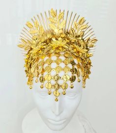 This headpiece is made of bright yellow gold metal parts (a bit warmer gold than in the pictures). It includes a forehead net with coins and tiny bells, and a 3D flower arrangement with spikes and leaf branches above it. It sits on a wide headband and will have an elastic connecting its edges unless you prefer not to have it. The headdress is quite shiny due to the golden colour of the metal, but additional accents canbe created by crystal application (including Swarovski crystals - please conta Handmade Gold Headpiece For Festivals, Traditional Gold Ceremonial Headpieces, Gold Tall Crown Headpiece Handmade, Traditional Gold Crown Headpiece, Ceremonial Crown Headpiece For Festivals, Handmade Gold Headpiece With Teardrop Crown, Gold Tall Crown Costume Hat, Gold Costume Hat With Tall Crown, Gold Tall Crown Fantasy Hat