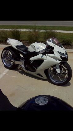 a white and black motorcycle parked in a parking lot