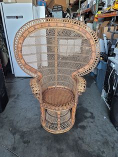 a wicker chair sitting on top of a floor next to a refrigerator