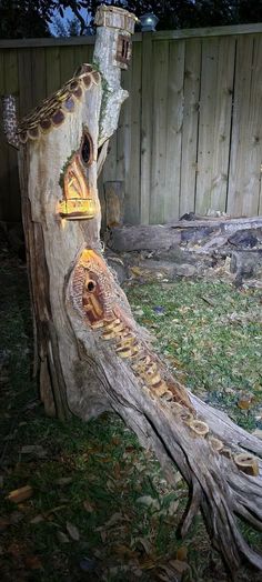 a tree stump that has been carved into a house