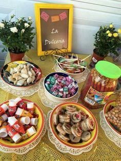 a table topped with lots of different types of snacks and condiments on top of plates