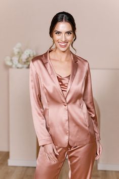 For the bridesmaid that doesn't want a dress, we have you covered! The new Ruby Satin Jacket & Pants set provides a glamorous alternative to a dress and will still have you feeling chic, confident, and comfortable all night long! The Ruby Jacket and Ruby Pants are sold separately. Lindsey size 4, pictured with the Flynn Satin Top in Desert Rose, sold separately. Laken size 24, pictured with the Heidi Chiffon Top in White Pearl, sold separately. FEATURES: Fitted Jacket silhouette Long sleeves Thr Luxury Satin Long Sleeve Suits, Glamorous Spring Wedding Blazer, Champagne Satin Pant Suit, Elegant Fitted Set For Wedding Night, Elegant Fitted Sets For Wedding Night, Fitted Bridesmaid Sets, Elegant Satin Outerwear For Wedding, Long Sleeve Satin Suits For Evening, Satin Long Sleeve Suits For Evening