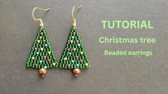 the beaded christmas tree earrings are on display