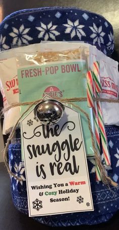 a gift bag filled with treats and candy canes for the snuggle is real