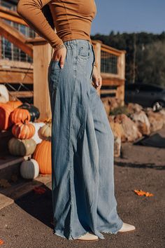 - These wide legged pants are a trendy option to add to your wardrobe! - Unlined chambray material - A waistline with an elastic back, belt loops, a hidden zip fly, and button closure - A functional five pocket cut - Pleated detail - An ultra relaxed silhouette that end in floor length frayed hemlines Fall Medium Wash High Rise Wide Leg Pants, Fall High Rise Medium Wash Wide Leg Pants, Medium Wash Washed Bottoms For Fall, Fall Medium Wash Washed Bottoms, Medium Wash Wide Leg Flare Jeans With Belt Loops, Wide Leg Washed Blue Flare Jeans With Belt Loops, Medium Wash Washed Pants For Fall, Wide Leg Denim Flare Jeans With Belt Loops, Fall Washed Denim Blue Pants