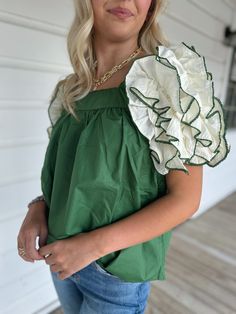 Adorable green top with off white ruffle sleeve detailing Model is 5’4” with a 25” waist, 32” bust and 32” hips wearing a small. Green Ruffle Hem Top For Spring, Green Puff Sleeve Blouse For Spring, Trendy Green Cotton Puff Sleeve Top, Chic Green Puff Sleeve Top, Summer Green Cotton Puff Sleeve Top, Green Ruffle Hem Tops For Summer, Green Cotton Puff Sleeve Top For Summer, Chic Green Puff Sleeve Fitted Top, Chic Green Fitted Puff Sleeve Top