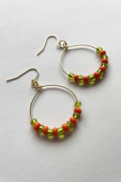 Made with gold plated posts and recycled beads, the Julia Earrings are not only fun, but also sustainable and great for those with sensitive ears. These lightweight hoops feature recycled orange and green beads. Nickel Free Orange Hoop Earrings, Orange Hoop Beaded Earrings As Gift, Orange Hoop Earrings With Colorful Beads For Gift, Everyday Green Round Bead Earrings, Everyday Green Round Beaded Earrings, Recycled Beads, Green Beads, Orange And Green, Hand Made Jewelry