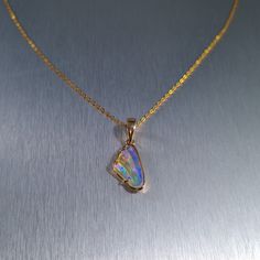 Solid carved Lightning Ridge crystal opal, set in a 14ct yellow gold pendant.  Chain not included. Opal Weight: 2.0ct Size: 16x8.8mm Pendant Length: 26mm Width: 10mm Depth: 4.5mm Materials: Lightning Ridge solid opal, 14ct yellow gold   Total Weight: 1.6gm Gold Opal Pendant Jewelry, Opal Jewelry With Polished Finish For Gift, Opal Cabochon Yellow Gold Jewelry, Yellow Gold Opal Cabochon Jewelry, Yellow Gold Ethiopian Opal Cabochon Jewelry, Iridescent Opal Pendant Jewelry, Polished Opal Pendant Jewelry, Gold Ethiopian Opal Cabochon Jewelry, Formal Gold Ethiopian Opal Jewelry