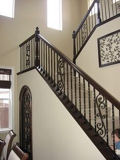 a staircase with wrought iron railings in a home