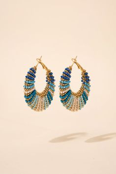 The beads are arranged in a bohemian style and come in a variety of shades. The earrings have a lightweight feel, making them comfortable for all-day wear. They feature a lever back hoop closure, which makes them easy to put on and take off. The beading creates a textured, layered look that adds visual interest to any outfit. Size Height: 1.85 in (4.70 cm)Width: 1.75 in (4.45 cm) Quality Made of metal alloy, and is adorned with both metal alloy and acrylic seed beads. Uses a lever back hoop clos Adjustable Beaded Chain Earrings For Beach, Bohemian Hoop Beaded Earrings With Colorful Beads, Bohemian Beaded Hoop Earrings For Beach, Bohemian Large Beads Hoop Beaded Earrings, Bohemian Large Beads Hoop Earrings, Bohemian Large Beaded Hoop Earrings, Bohemian Hoop Earrings With Large Beads, Blue Bohemian Beaded Small Hoop Earrings, Bohemian Blue Beaded Small Hoop Earrings