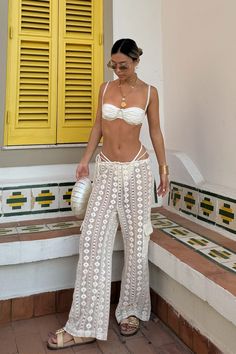 Say hello to the only pants you will need this summer. The Amore Beige Crochet Cargo Pants was designed with the beach in mind, made in a super lightweight crochet material, perfect to throw on over your swimsuit and go. Grab your sandals and we’ll meet you where the sunset meets the shoreline. Summer Crochet Lace Bottoms For Beach Season, Dress As A Wedding Guest, Crochet Beach Pants, Island Fits, Tulum Outfits, Party Bottoms, Travel Fits, Beige Crochet, Fest Outfits