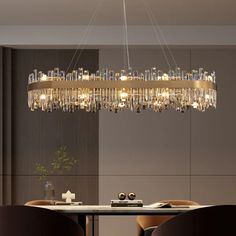 a modern chandelier hanging over a dining room table