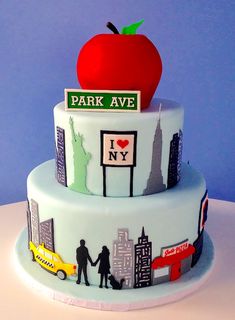 a three tiered cake with an apple on top and the words park ave painted on it