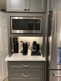 a stainless steel refrigerator and microwave in a kitchen