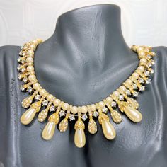 Vintage Teardrop Faux Pearl and Rhinestone Gold Tone Statement Choker Necklace - Elegant Dressy Formal - Teardrop Encrusted Rhinestone Pendants Vintage Necklace Brand: Unsigned  Era: Vintage Description: - Teardrop Shaped Faux Pearls and Teardrop Pendants Encrusted with Rhinestones - Snap Closure - Elegant Piece - Great for any formal occasion - Nice Piece If You Have an Upcoming Cruise to Wear on Formal Dinner Night  Condition: 2 Rhinestones Missing at Snap Clasp Length: 16 Inches / 41 CM Some of my pieces are vintage with a natural patina that many clients enjoy. I love cleaning jewelry (I find it relaxing), I will be happy to clean a piece for you after you purchase, just let me know. Disclaimer: this may cause a short delay in shipping.  Thank you so much for considering my piece! Plea Elegant Embellished Rhinestone Necklace For Wedding, Crystal Drop Bridal Necklace For Party, Elegant Embellished Crystal Rhinestone Necklace, Drop Crystal Bridal Necklace For Party, Elegant Crystal Embellished Rhinestone Necklace, Elegant Embellished Rhinestone Necklace For Party, Glamorous Embellished Formal Necklaces, Elegant Jeweled Bridal Necklace For Party, Glamorous Formal Embellished Necklaces