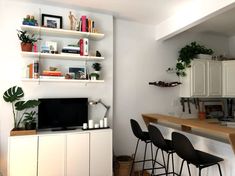 a living room filled with furniture and a flat screen tv sitting on top of a wooden table