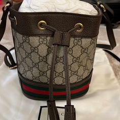 Brand New With Original Dust Bag Authentic Gucci Ophidia Mini Bucket Bag. Dimensions Are 6’w X 7.5’ H X 3.5’ D. Beige And Brown Gg Supreme Canvas. Poshmark Will Authentic Anything Over $500. I Have Original Receipt If Needed. Add This To Your Holiday Attire Or Make It A Gift! Gucci Bucket Bag With Gold-tone Hardware, Gucci Bucket Bag With Gold-tone Hardware For Travel, Gucci Brown Shoulder Bag With Adjustable Strap, Brown Gucci Shoulder Bag With Adjustable Strap, Designer Gucci Bucket Bag With Detachable Strap, Gucci Chic Bucket Bag With Gold-tone Hardware, Chic Gucci Bucket Bag With Gold-tone Hardware, Gucci Brown Bag With Adjustable Strap, Gucci Bucket Bag For Travel