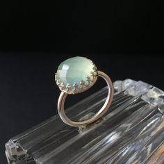 "The beautiful designer ring is  a handmade, high-quality one-of-a-kind jewelry piece that I crafted from Argentium sterling silver and checkerboard cut, aqua chalcedony cabochon and a polished round Sterling silver ring band. The translucent gemstone has a beautiful light blue  color and creates a delicate and young designer ring. The 12 mm, checkerboard cut, water blue Chalcedony stone is hand set in this gallery bezel. The Sterling silver ring band is very comfy. Argentium is a type of sterli Delicate Silver Rings, Blue Chalcedony Ring, Aqua Chalcedony Ring, Silver Ring Band, Chalcedony Stone, Chalcedony Ring, Water Blue, Sterling Silver Rings Bands, Aqua Chalcedony